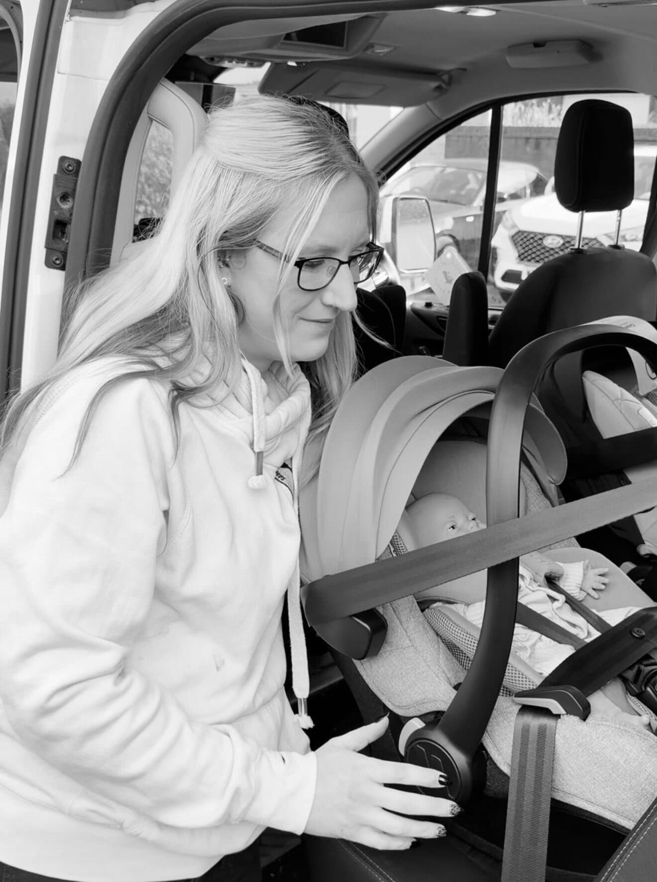 Charlene installing a newborn rear-facing car seat